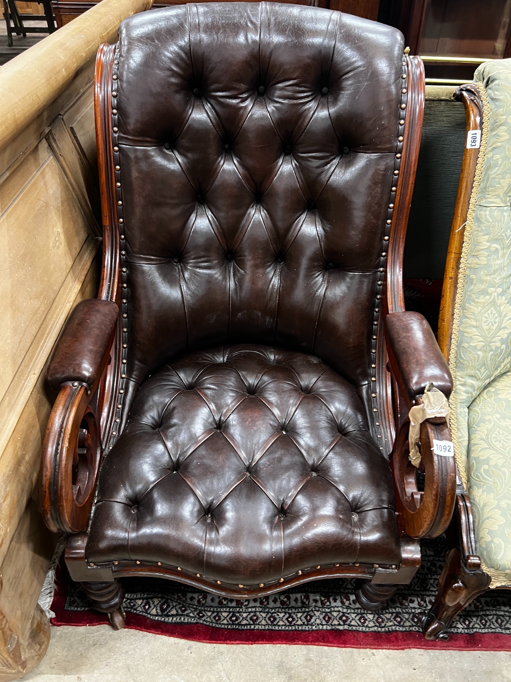 A Victorian mahogany armchair upholstered in deep buttoned brown leather, width 68cm, depth 80cm, height 96cm